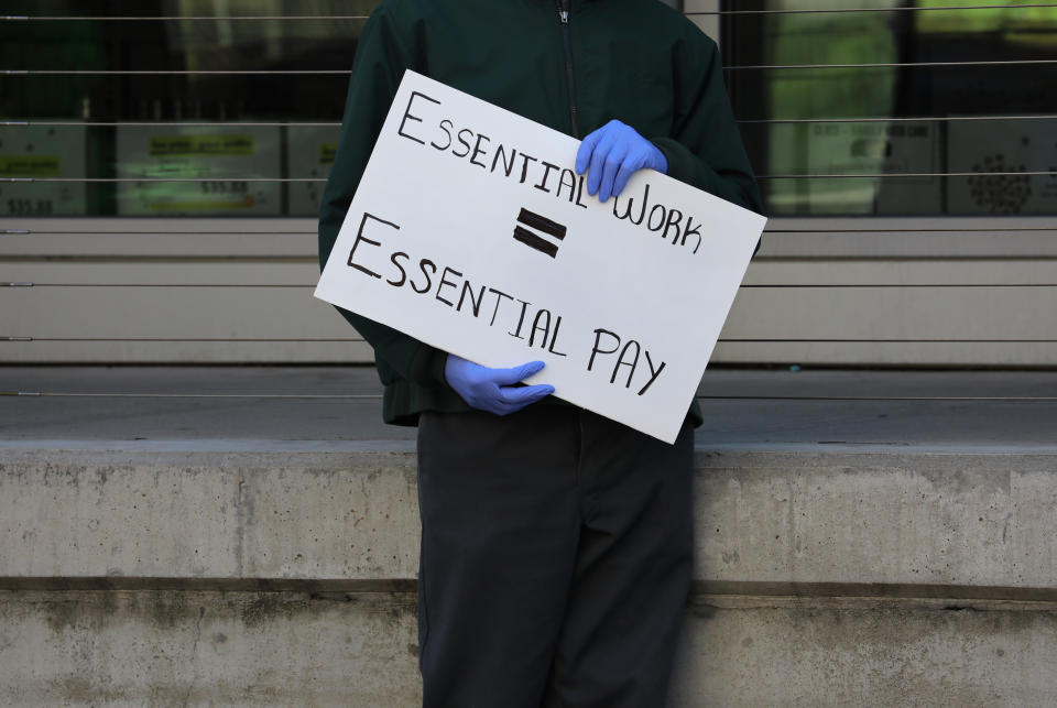 BOSTON, MA - APRIL 7: Grocery store workers and others stage a protest rally outside the Whole Foods Market, in the South End of Boston, to demand personal protective equipment, added benefits if needed and hazard pay, during the coronavirus pandemic on Apr. 7, 2020. (Photo by Pat Greenhouse/The Boston Globe via Getty Images)