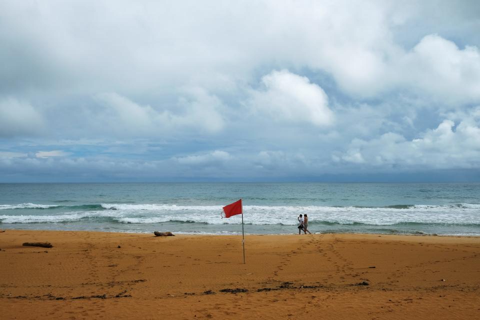 A red flag warns of rip currents in Puerto Rico in 2019.