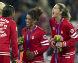 Canada women's soccer players Robyn Gayle (left), Desiree Scott and Christine Sinclair (right) share a laugh after being presented with their Bronze medals at the Olympic Games in London on Thursday August 9, 2012. THE CANADIAN PRESS/Frank Gunn