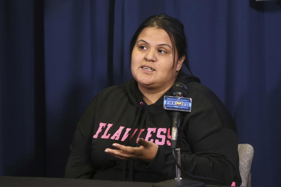 Shannon Vivar, 27, who had her vehicle hit by a red light runner, speaks at Phoenix Police headquarters about her ordeal Thursday, Oct. 24, 2019, in Phoenix. Authorities say 28-year-old Ernesto Otanez Oveso is accused of running a red light Oct. 14 in a hit-and-run car crash that nearly struck a couple pushing a stroller across a busy Phoenix street, and remains jailed on suspicion of leaving the scene of a collision and aggravated assault along with a weapons violation, a felony warrant in a probation violation and three misdemeanor warrants. (AP Photo/Ross D. Franklin)