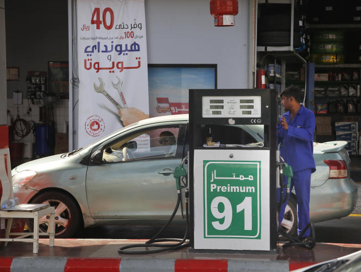 A worker refuels a car at a gas station in Jiddah, Saudi Arabia, Monday, Sept. 16, 2019. Global energy prices spiked on Monday after a weekend attack on key oil facilities in Saudi Arabia caused the worst disruption to world supplies on record, an assault for which President Donald Trump warned that the U.S. was "locked and loaded" to respond. (AP Photo/Amr Nabil)