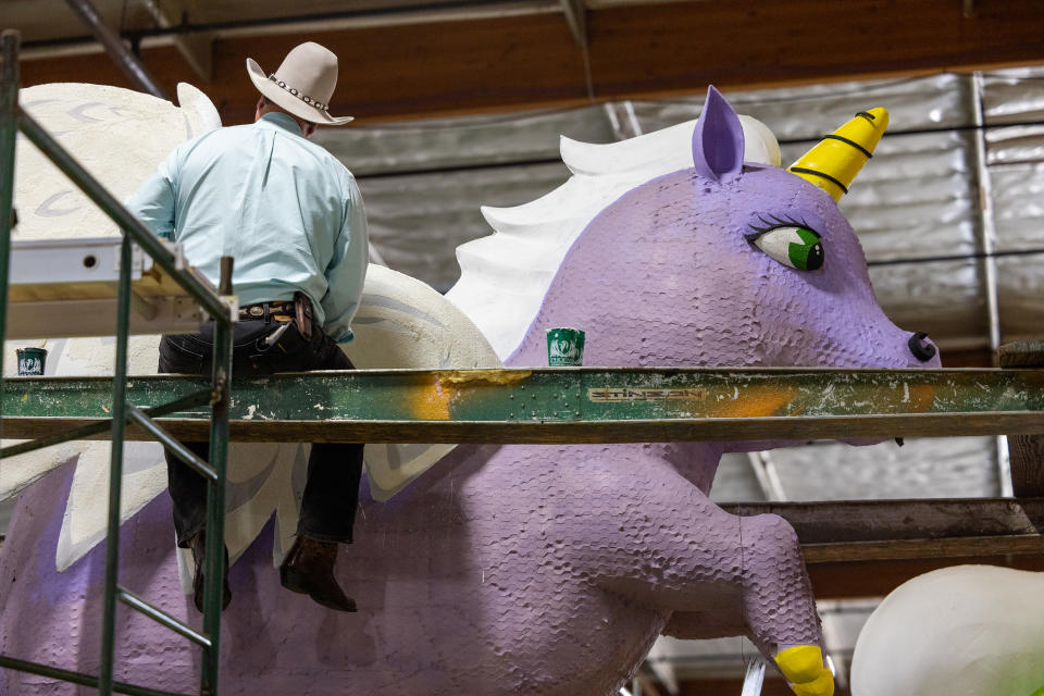 Volunteer Steve Camarillo decorates Odd Fellows & Rebekahs "All We Need is Love" Rose Parade float