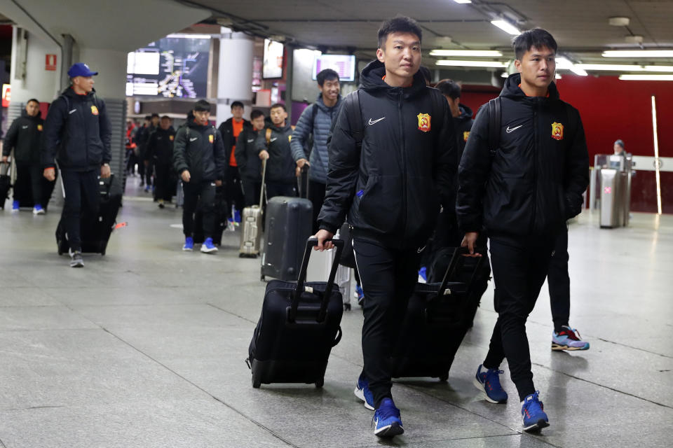 Players of the Chinese Super League team Wuhan Zall arrive at the Atocha train station in Madrid, Spain, Saturday, Feb. 29, 2020. The Chinese first-division soccer club from the city of Wuhan enters its second month in Spain without knowing when it will be able to return home. . It hasn't been easy for the nearly 50 members of the Wuhan Zall squad, but on Sunday they will get some reprieve from their ordeal by attending the Spanish league "clasico" between Real Madrid and Barcelona at the Santiago Bernabeu Stadium in Madrid. (AP Photo/Manu Fernandez)