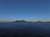 The moon rises over the pine-covered mountains surrounding the Indigenous township of Cheran, Michoacan state, Mexico, Wednesday, Jan. 19, 2022. Avocados have been nothing short of a miracle crop for thousands of small farmers in Michoacan; with a few acres of well-tended avocado trees, small landholders can send their kids to college or buy a pickup truck, something no other crop allows them to do. But because of the immense amount of water they need, the expansion of avocados has come by moving into humid pine forests. (AP Photo/Fernando Llano)