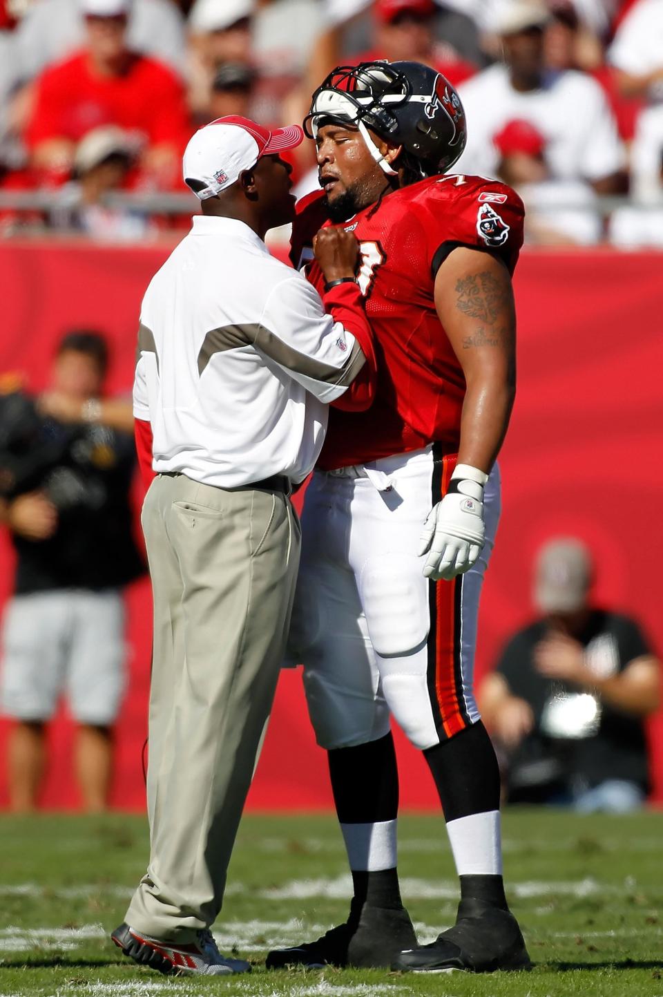 TAMPA, FL - NOVEMBER 14:  Head coach Raheem Morris of the Tampa Bay Buccaneers has some words for offensive lineman Donald Penn #70 during the game against the Carolina Panthers at Raymond James Stadium on November 14, 2010 in Tampa, Florida.  (Photo by J. Meric/Getty Images)