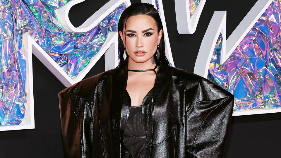 Demi Lovato looked edgy in an oversized geometric black coat layered with a mesh and leather mini dress from the up-and-coming Chinese label Buerlangma. - Jamie McCarthy/WireImage/Getty Images