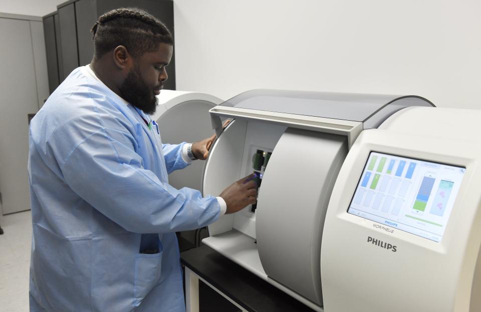 UF Health Jacksonville digital pathology prep tech Reginald Hyacinthe loads a cartridge of slides containing tissue samples into a digital scanner to be sent to for analysis. The University of Florida College of Medicine-Jacksonville is using the first federally approved artificial intelligence-based software to help make diagnoses.