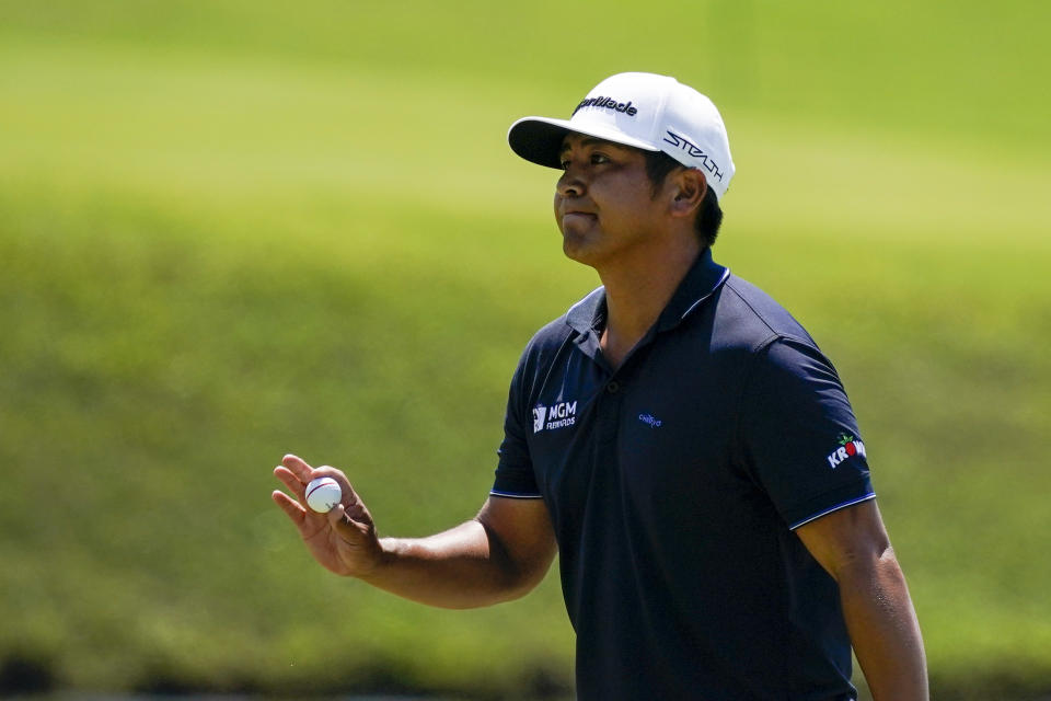 Kurt Kitayama, of the United States, holds up his golf ball at the first hole green during the final round of the Mexico Open at Vidanta in Puerto Vallarta, Mexico, Sunday, May 1, 2022. (AP Photo/Eduardo Verdugo)