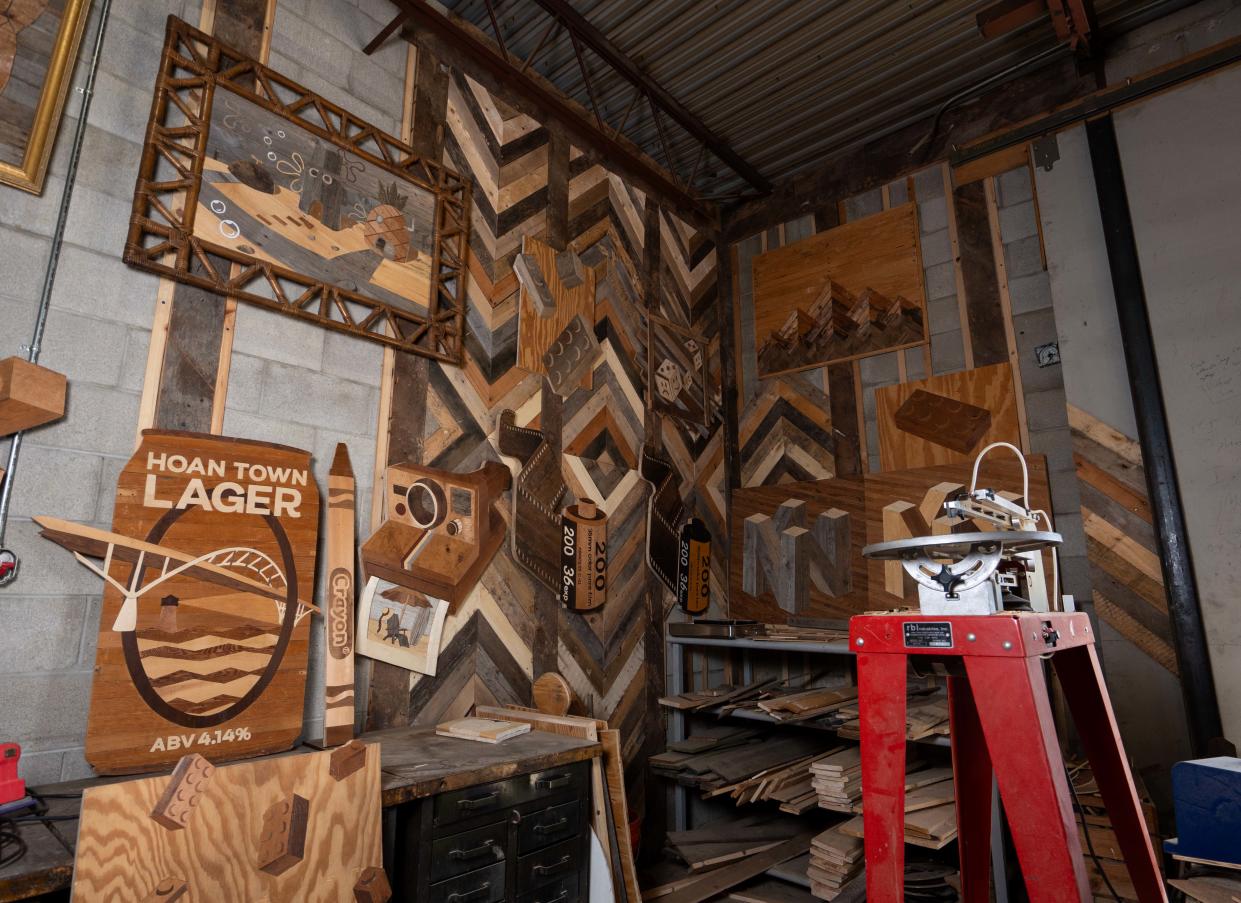 Wisconsin wood artist Ike Wynter, who uses discarded wood to make art that focuses on nostalgia and mental health awareness, has a work space filled with past art pieces on Wednesday, June 12, 2024, in Butler, Wisconsin.