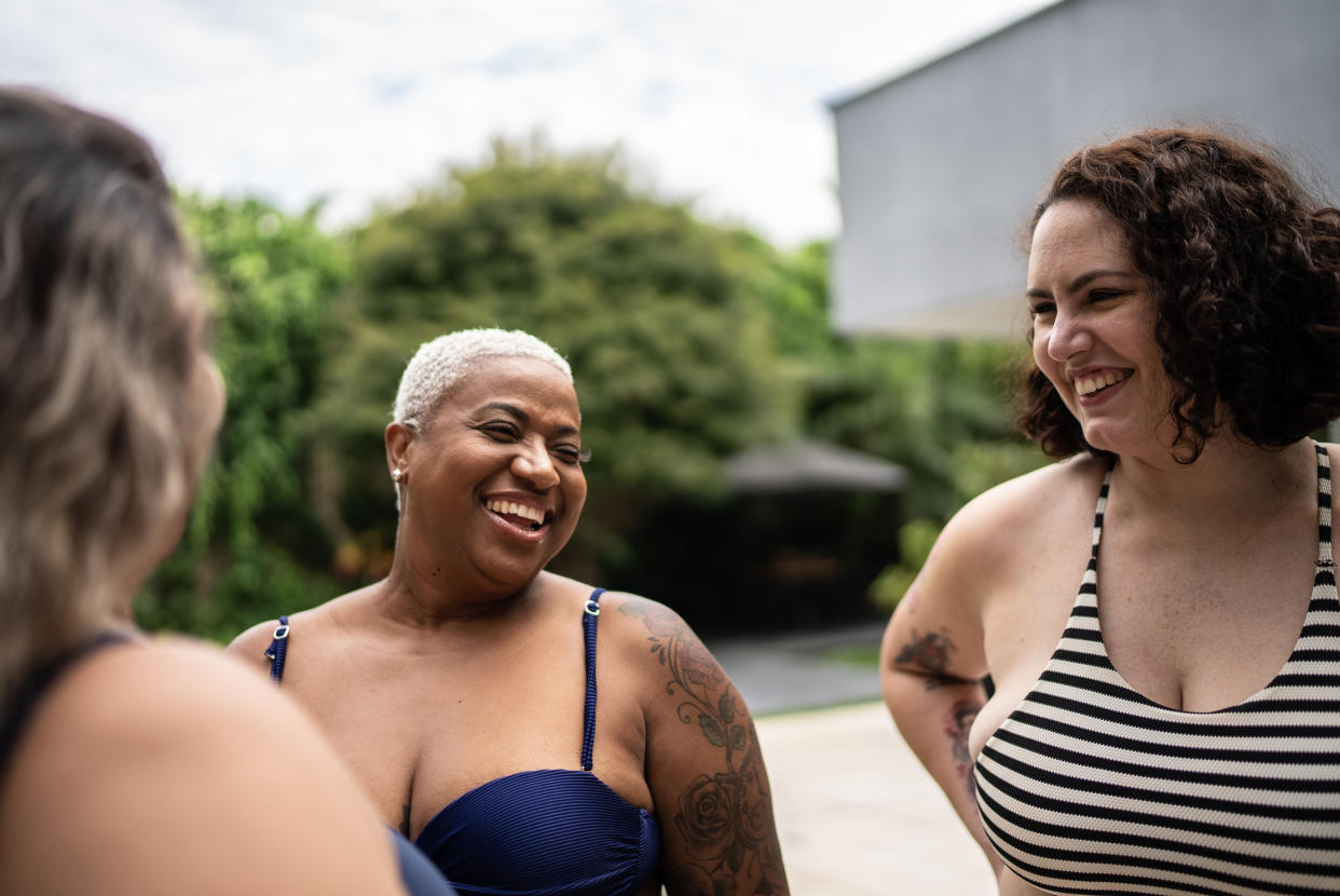 Three women wearing swimsuits.