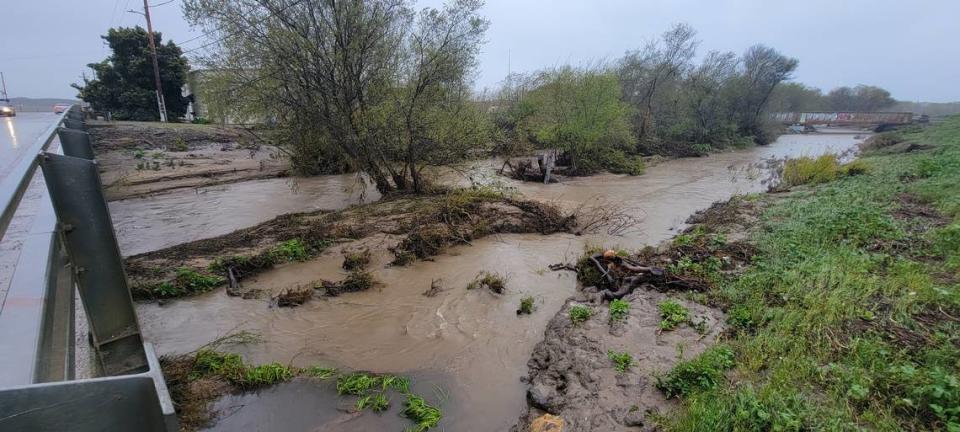 Arroyo Grande Creek flows under the 22nd Street Bridge in Oceano as a new storm hit the county on March 14, 2023. Laura Dickinson/ldickinson@thetribunenews.com