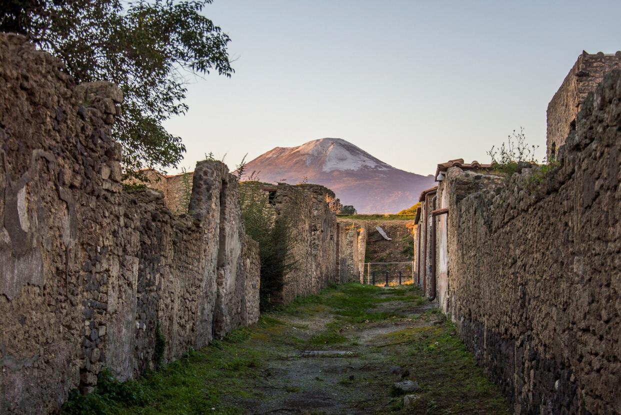 Ruines of the ancient Roman city of Pompeii and mount Vesuvius in the evening light, Italy