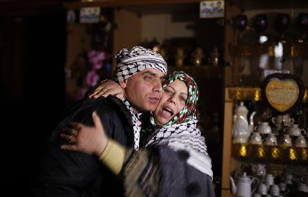 Freed Palestinian prisoner Rami Barbakh, who was held by Israel for 20 years, is hugged by his mother at his house in Khan Younis, in the southern Gaza Strip December 31, 2013. Israel freed 26 Palestinian prisoners on Tuesday, days before U.S. Secretary of State John Kerry was due back in the Middle East to press the two sides to agree a framework peace deal. REUTERS/Ibraheem Abu Mustafa