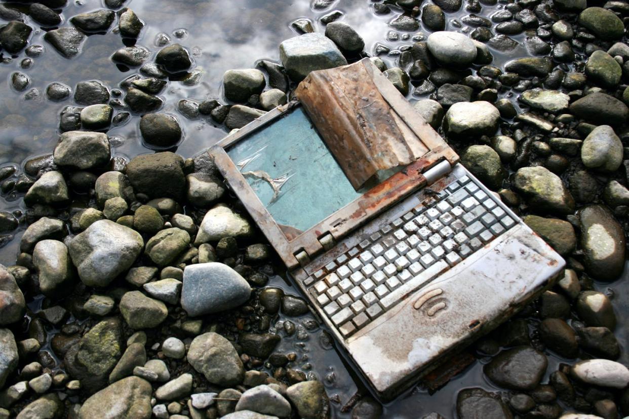 <span class="caption">Most of the world's electronics are not recycled, posing health and environmental risks. </span> <span class="attribution"><a class="link " href="https://www.gettyimages.com/detail/photo/abandoned-and-rusted-laptop-lying-on-riverbed-royalty-free-image/108162816" rel="nofollow noopener" target="_blank" data-ylk="slk:catscandotcom/Getty Images;elm:context_link;itc:0;sec:content-canvas">catscandotcom/Getty Images</a></span>