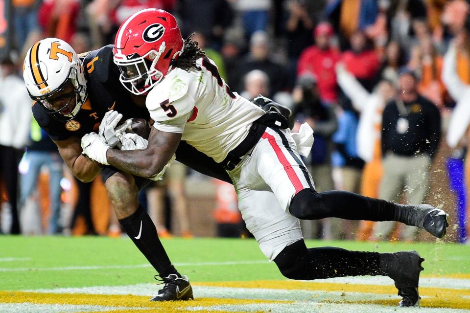 Tennessee wide receiver Cedric Tillman (4) scores a touchdown as Georgia defensive back Kelee Ringo (5) defends Nov.13, 2021, in Knoxville, Tenn.