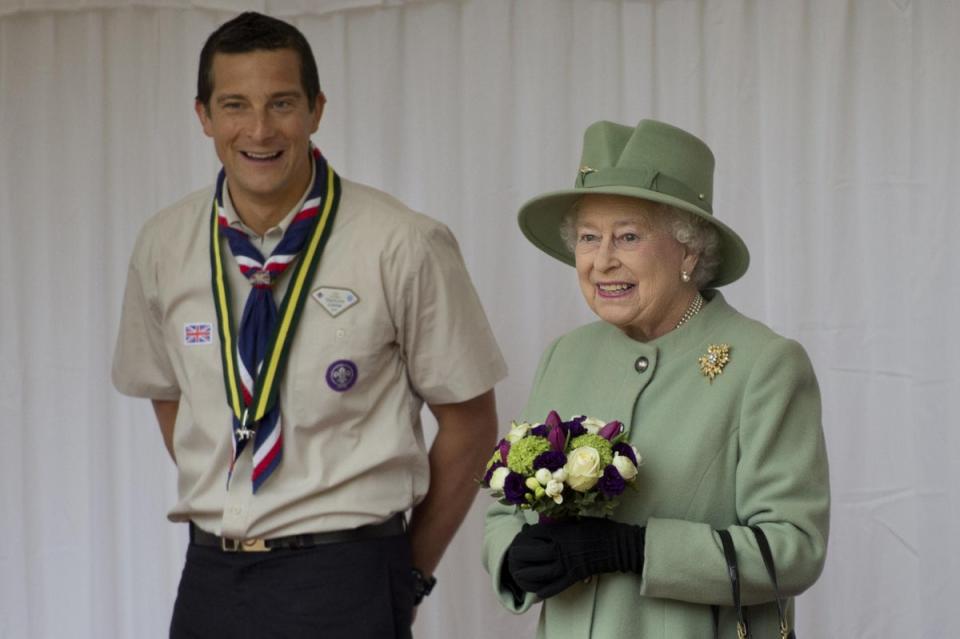 Chief Scout, Bear Grylls, left, watches as Queen Elizabeth II reviews the Queen’s Scouts at Windsor Castle (Ben Stansall/PA) (PA Archive)