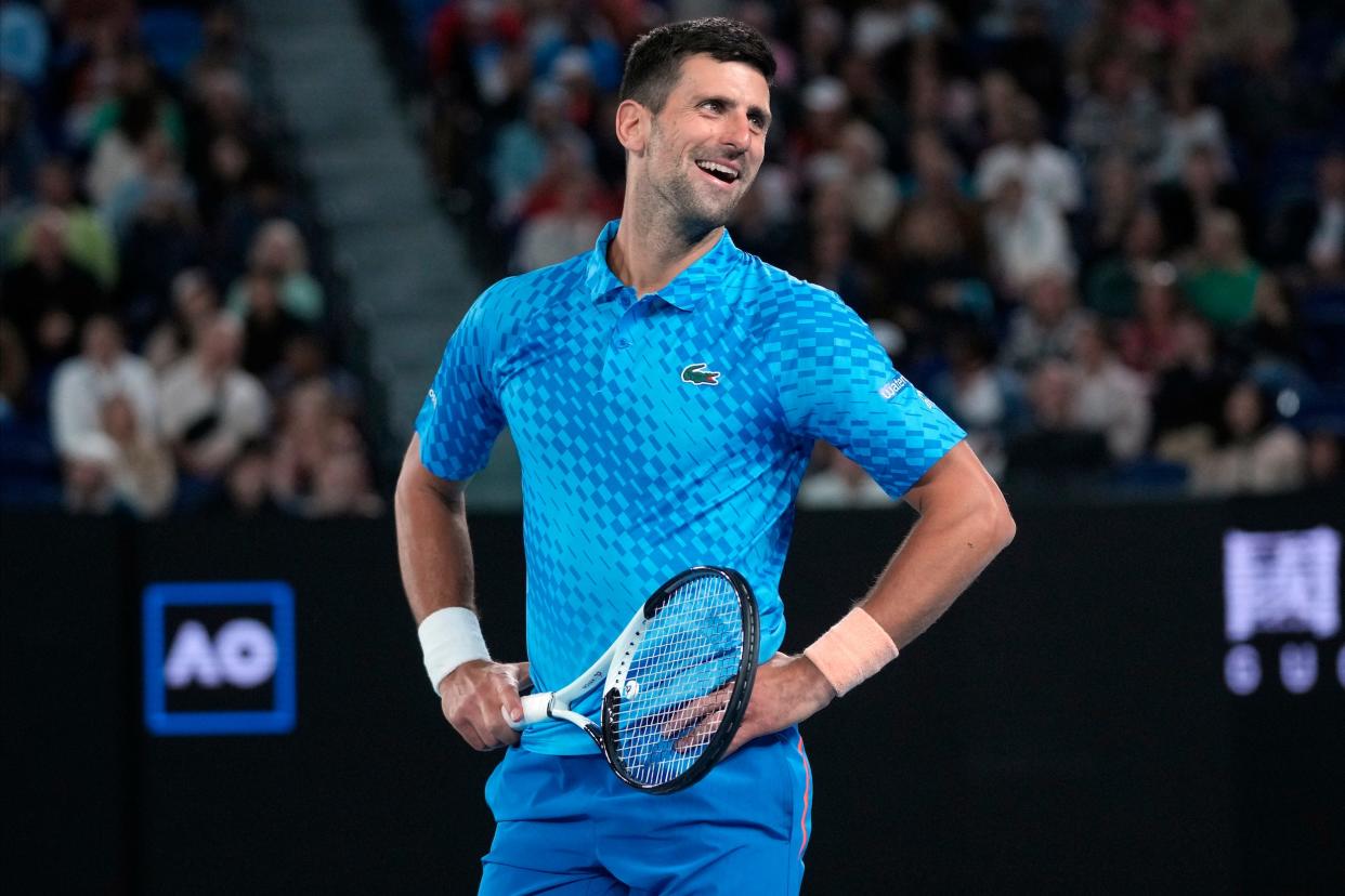 Novak Djokovic smiles at the crowd while competing at the 2023 Australian Open.