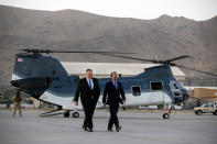 Secretary of State Mike Pompeo, left, walks from a helicopter with U.S. Ambassador to Afghanistan John Bass, Tuesday, June 25, 2019, as Pompeo returns to his plane after an unannounced visit to Kabul, Afghanistan. (AP Photo/Jacquelyn Martin, Pool)