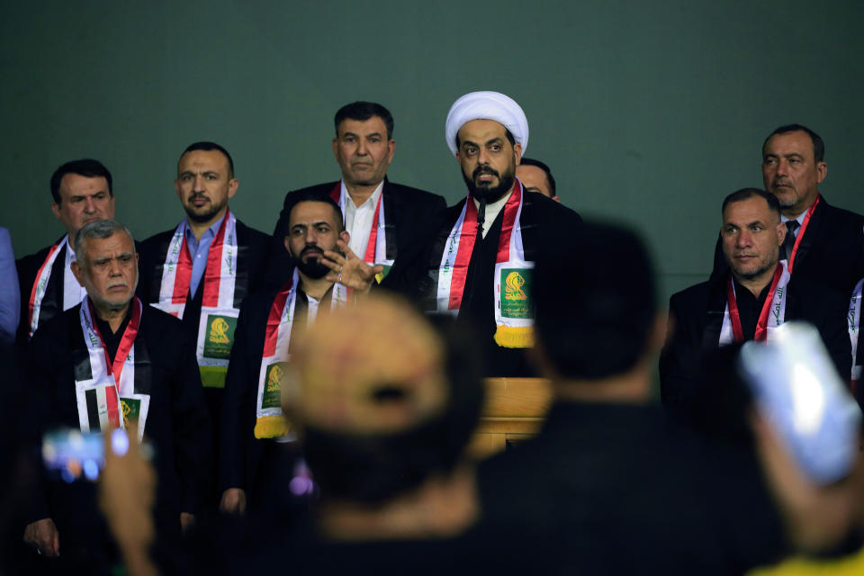 FILE - Qais al-Khazali, center, the leader of the militant Shiite group Asaib Ahl al-Haq, or League of the Righteous, and member in a political movement called "Al-Fateh Alliance" attends a rally before the parliamentary elections in Baghdad, Iraq, Tuesday, Oct. 5, 2021. More than seven months after national elections, Iraq still doesn't have a government. Driven by cutthroat competition for power and resources between elites, there is no clear way out of the unprecedented impasse. (AP Photo/Hadi MizbanFile)