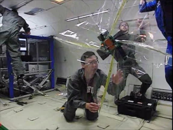 This still from an experiment video shows a tiny cubesat satellite prototype after deploying a folded sail in weightlessness aboard NASA's "Vomit Comet" research plane.