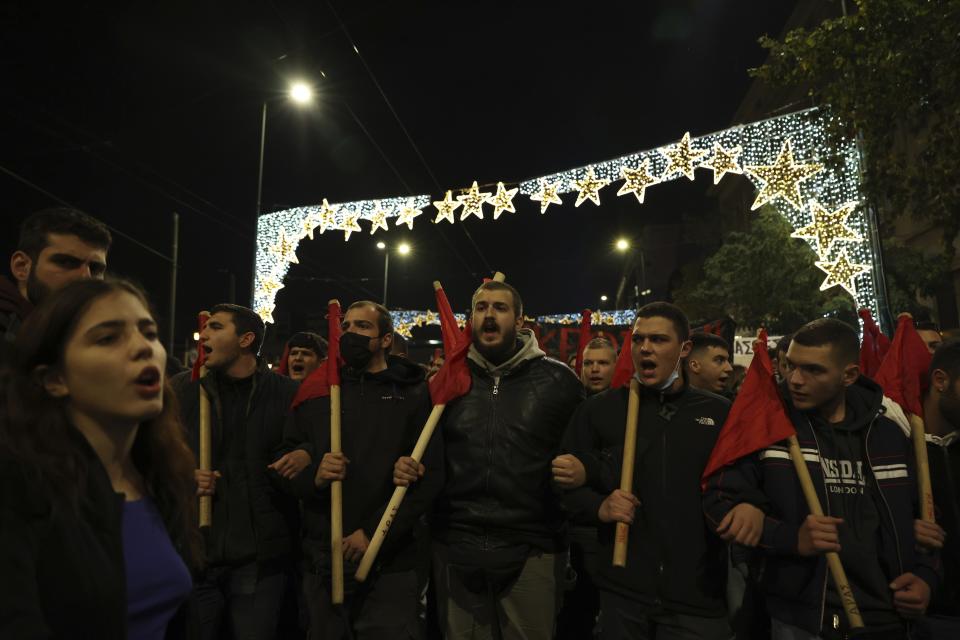 Protesters take part in a rally against police in Athens, Greece, Tuesday, Dec. 13, 2022. Leaders of the Roma community in northern Greece have appealed for calm as student and anarchist groups called rallies to protest the death Tuesday of a Roma teenager. The 16-year-old had been shot in the head during a police chase last week over an allegedly unpaid gas station bill. (AP Photo/Yorgos Karahalis)