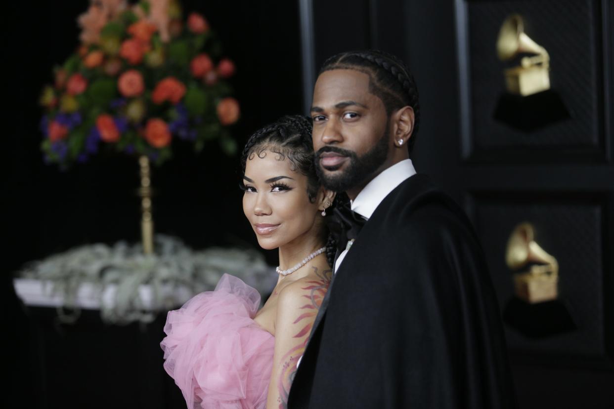 Jhene Aiko in a pink dress and Big Sean in a black tuxedo jacket