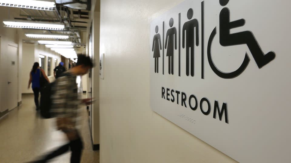 Students pass by a sign for a unisex bathroom next to the men's and women's restrooms at the University of Houston Downtown, Nov. 5, 2015. - Mark Mulligan/Houston Chronicle/Getty Images