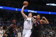 Dallas Mavericks guard Luka Doncic (77) shoots against Toronto Raptors forward Scottie Barnes (4) as Mavericks' Maxi Kleber (42) and Raptors forward Pascal Siakam (43) watch during the first half of an NBA basketball game in Dallas, Wednesday, Jan. 19, 2022. (AP Photo/LM Otero)