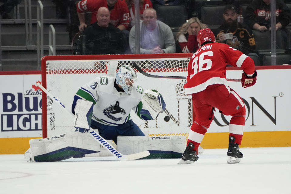 Detroit Red Wings defenseman Jake Walman (96) scores on a penalty shot on Vancouver Canucks goaltender Casey DeSmith (29) during overtime in an NHL hockey game Saturday, Feb. 10, 2024, in Detroit. (AP Photo/Paul Sancya)