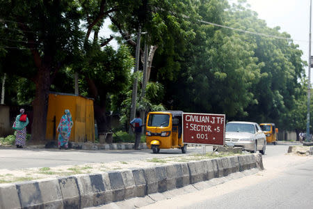 A car drives towards a Civilian Joint Task Force (CJTF) sector 5 sign in Maiduguri, Nigeria August 30, 2016. REUTERS/Afolabi Sotunde