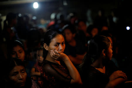 Friends and family members attend a service for Jakelin Caal, a 7-year-old girl who handed herself in to U.S. border agents earlier this month and died after developing a high fever while in the custody of U.S. Customs and Border Protection, at her home village of San Antonio Secortez, Raxruha in Guatemala December 24, 2018. REUTERS/Carlos Barria
