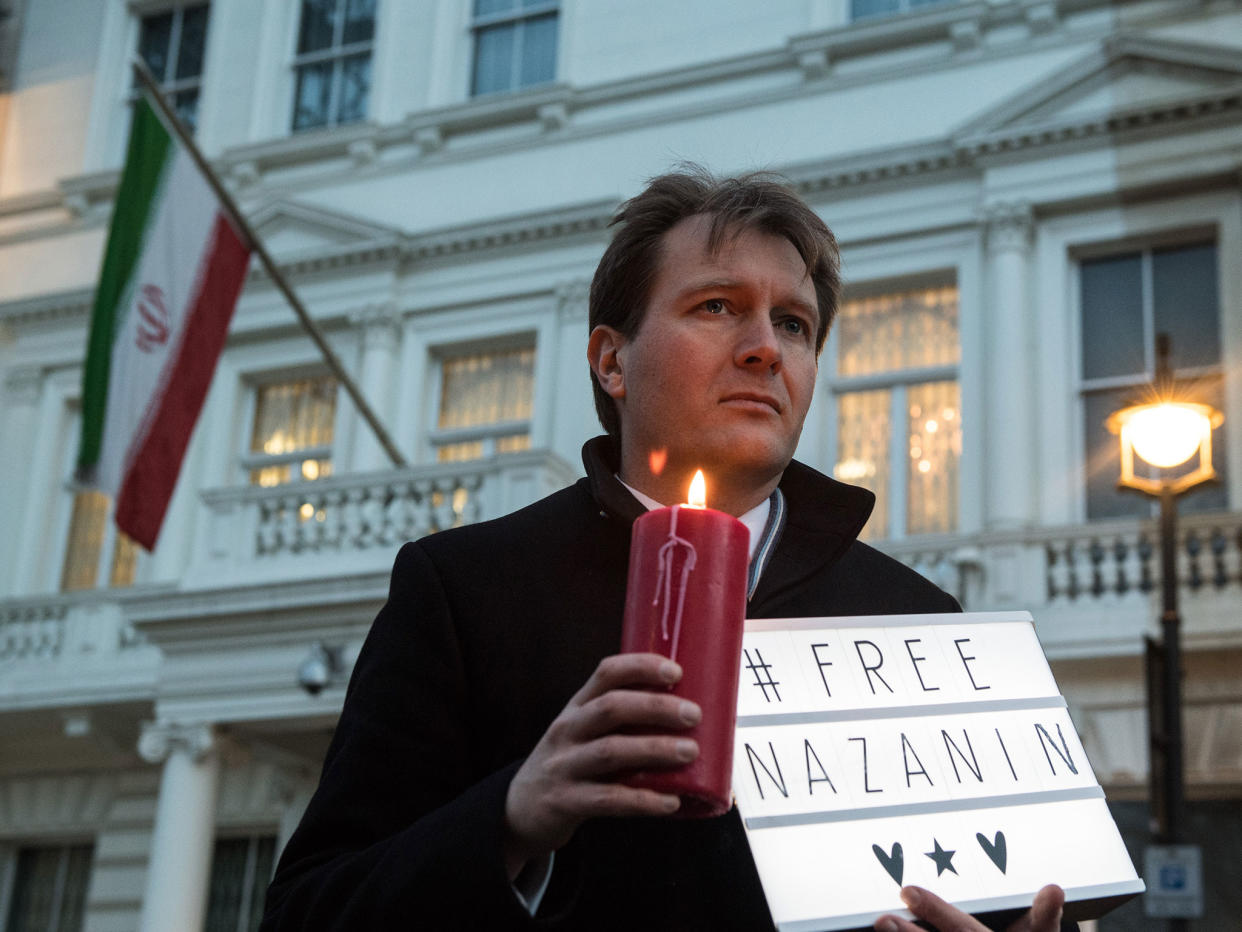Richard Ratcliffe, husband of Nazanin Zaghari-Ratcliffe holds a '#Free Nazanin' sign and candle during a vigil for the British-Iranian mother: Getty