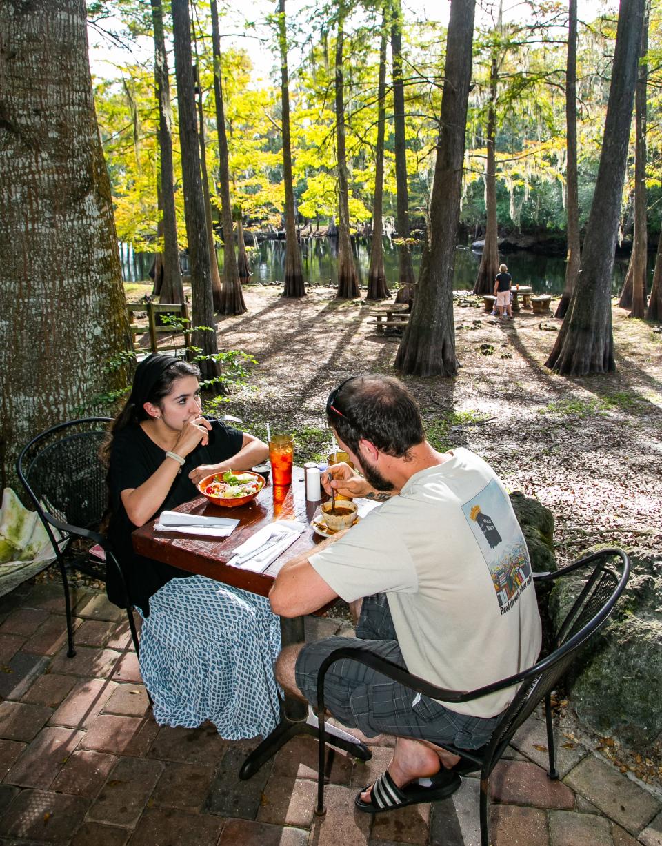 Kaitlin and Robert Henderson enjoy an early dinner at Stumpknockers on the Withlacoochee River Wednesday afternoon, October  20, 2021 located at 13821 SW State Road 200 in Dunnellon. Patrons enjoy drinks on the Rainbow River at Swampy's in Dunnellon, FL locate at 19773 E. Pennsylvania Ave. [Doug Engle/Ocala Star-Banner]2021