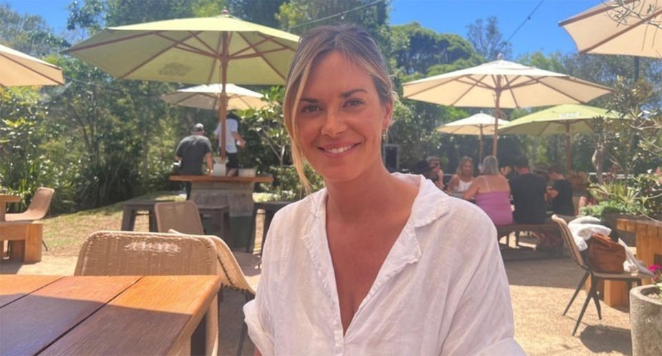 Belinda Checkley sits at a cafe table