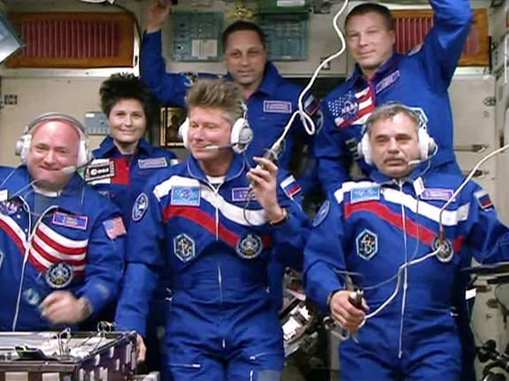 NASA astronaut Scott Kelly (bottom left) and Russian cosmonauts Gennady Padalka (bottom center) and Mikhail Kornienko (bottom right) are seen on the International Space Station after arriving at the outpost on March 27, 2015. Kelly and Kornien