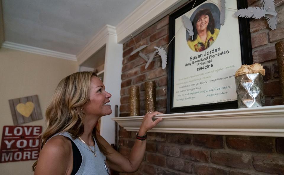 Amy Dinwiddie looks up at a photo of her mother, Susan Jordan on Wednesday, May 10, 2023 at at their home in Indianapolis. 