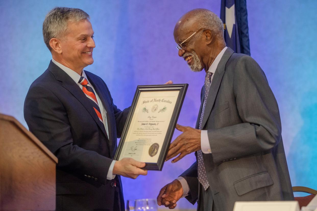 North Carolina Attorney General Josh Stein presents James Ferguson with the Order of the Long Leaf Pine at the MLK, Jr. Prayer Breakfast, January 13, 2024.