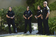 Police stand outside an apartment complex believed to be associated with a car crash suspect in Sunnyvale, Calif., on Wednesday, April 24, 2019. Investigators are working to determine the cause of the crash in Northern California that injured several pedestrians on Tuesday evening. Authorities say the driver of the car was taken into custody after he appeared to deliberately plow into the group. (AP Photo/Cody Glenn)