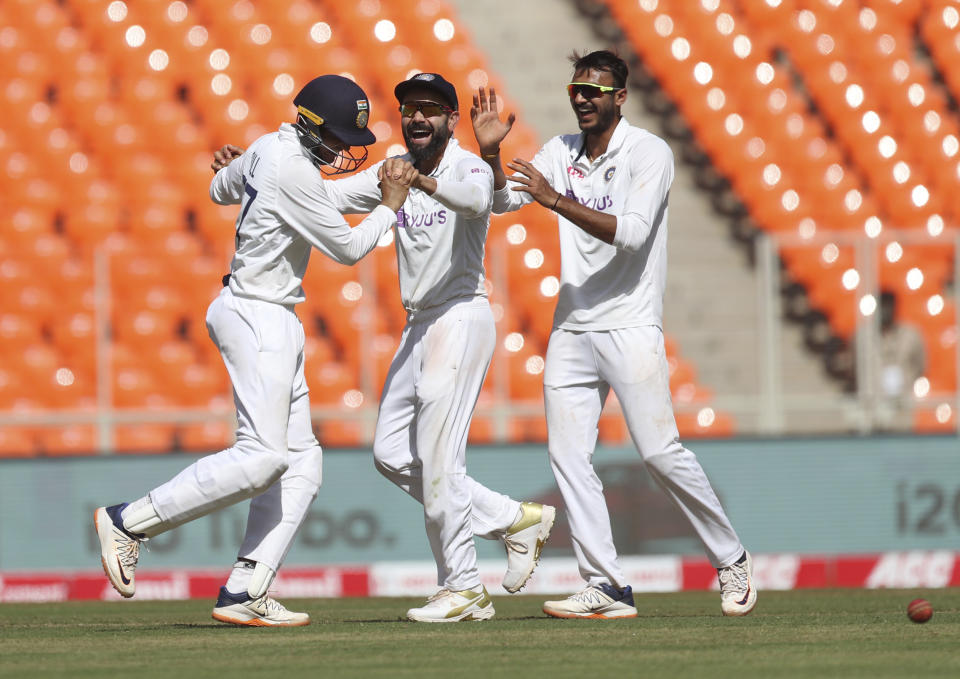 India's captain Virat Kohli, center, and teammates Axar Patel, right, and Shubman Gill celebrate before England's Dan Lawrence was given not-out by the third umpire during the first day of fourth cricket test match between India and England at Narendra Modi Stadium in Ahmedabad, India, Thursday, March 4, 2021. (AP Photo/Aijaz Rahi)