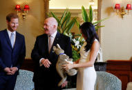 Australia's Governor General Peter Cosgrove gestures to a plush kangaroo as Britain's Prince Harry and wife Meghan, Duchess of Sussex look on at Admiralty House during their visit in Sydney, Australia October 16, 2018. REUTERS/Phil Noble/Pool