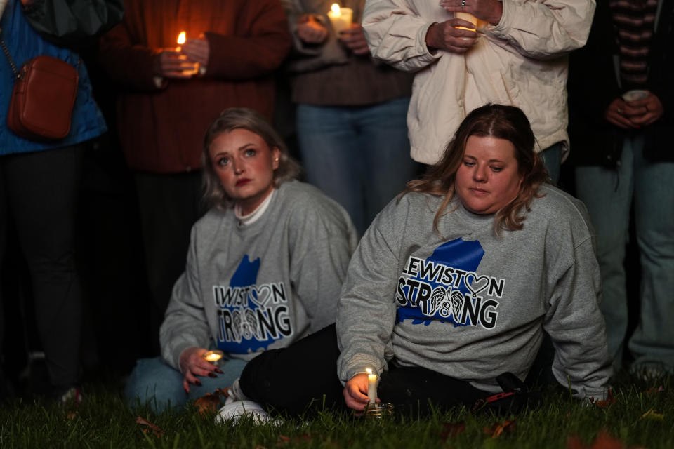 People gather at a vigil for the victims of Wednesday's mass shootings, Sunday, Oct. 29, 2023, outside the Basilica of Saints Peter and Paul in Lewiston, Maine. (AP Photo/Matt Rourke)