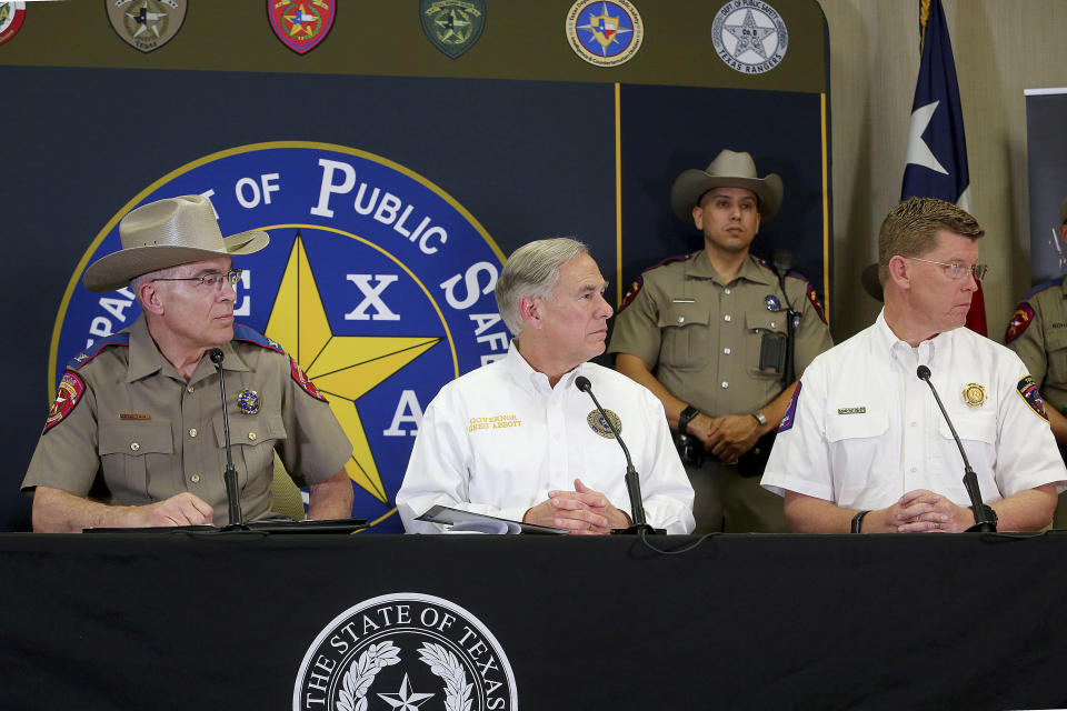 FILE - DPS Director Steve McCraw, from left, Texas Governor Greg Abbott and Chef of the Texas Division of Emergency Management W. Nim Kidd, listen to a question a press conference at the Texas Department of Public Safety Weslaco Regional Office, April 6, 2022, in Weslaco, Texas. About 3 in 10 also worry that more immigration can cause native-born Americans to lose their economic, political and cultural influence, according to a poll by The Associated Press-NORC Center for Public Affairs Research. (Joel Martinez/The Monitor via AP, File)