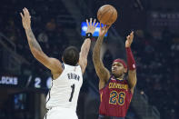 Cleveland Cavaliers' Brandon Goodwin (26) shoots over Brooklyn Nets' Bruce Brown (1) in the first half of an NBA basketball game, Monday, Jan. 17, 2022, in Cleveland. (AP Photo/Tony Dejak)