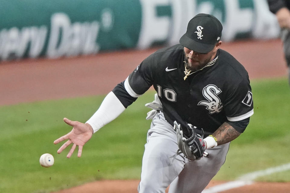 Chicago White Sox's Yoan Moncada can't hang onto a ball hit by Cleveland Indians' Franmil Reyes in the sixth inning of a baseball game, Tuesday, Sept. 22, 2020, in Cleveland. Reyes was safe at first base. (AP Photo/Tony Dejak)