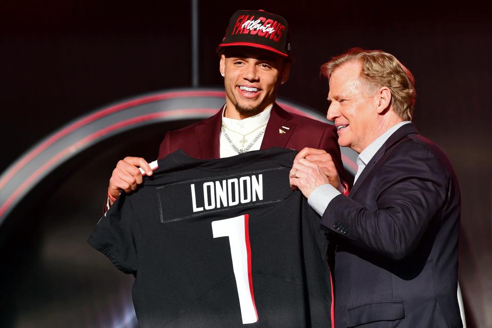 Drake London displays his Falcons jersey while posing for a photo with NFL commissioner Roger Goodell during the NFL Draft in Las Vegas on Thursday night. The Moorpark High graduate and former USC star was selected eighth overall.