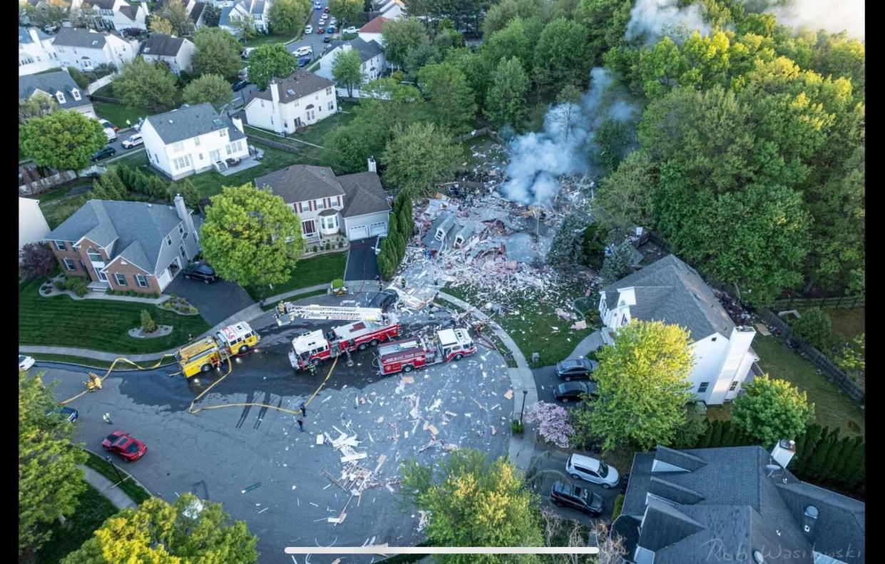 Authorities were investigating the cause of a home explosion in South River Thursday evening that left one man dead and another injured.