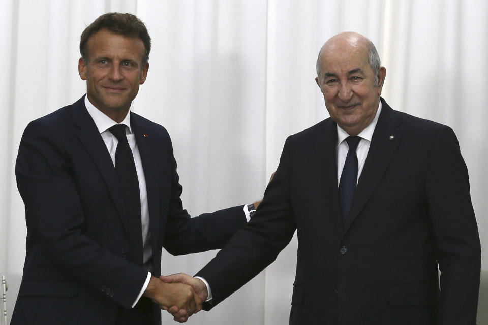 French President Emmanuel Macron, left, shakes hands with Algerian President Abdelmajid Tebboune before their talks, Thursday, Aug. 25, 2022 in Algiers. French President Emmanuel Macron is in Algeria for a three-day official visit aimed at addressing two major challenges: boosting future economic relations while seeking to heal wounds inherited from the colonial era, 60 years after the North African country won its independence from France. (AP Photo/Anis Belghoul)