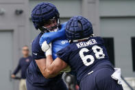 Chicago Bears offensive line Michael Schofield, left, works with offensive line Doug Kramer at the NFL football team's training camp, Thursday, July 28, 2022, in Lake Forest, Ill. (AP Photo/Nam Y. Huh)