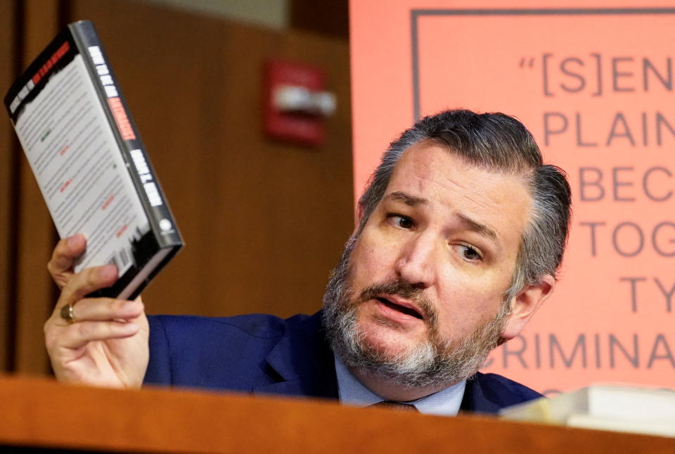 Senator Ted Cruz holds up the book How to Be an Antiracist as he questions Judge Ketanji Brown Jackson at her confirmation hearing.