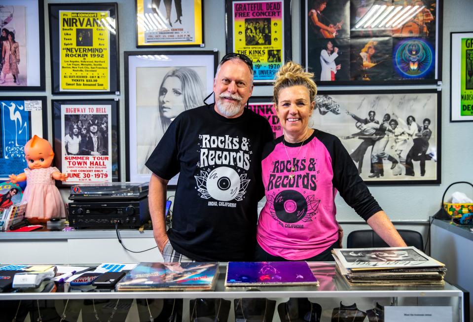Partners and co-owners Holger and Cristina Nagel of Rocks & Records in Indio pose while sorting through recently acquired records.